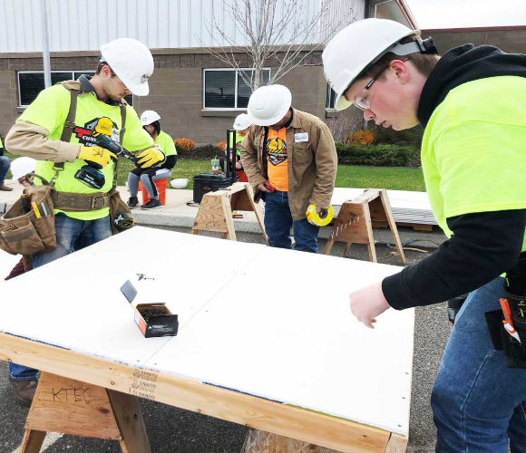 men in bright green safety vests doing construction