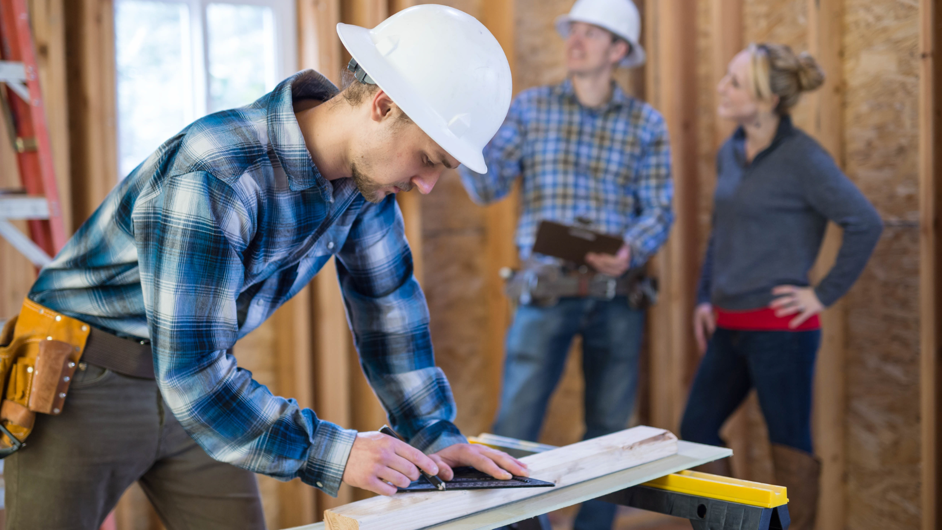 contractor working on blueprints inside of a home construction