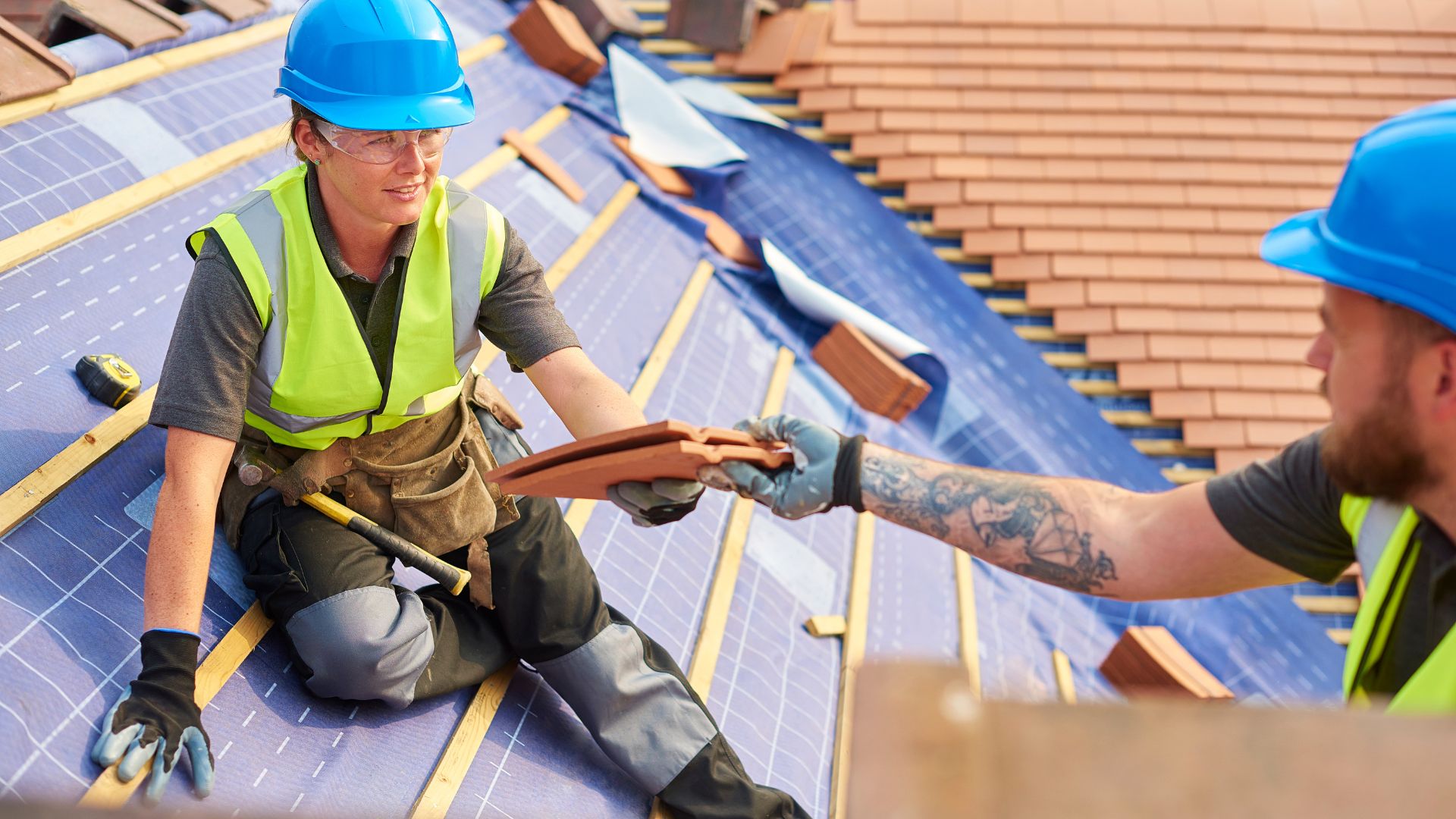 two roofers building a roof